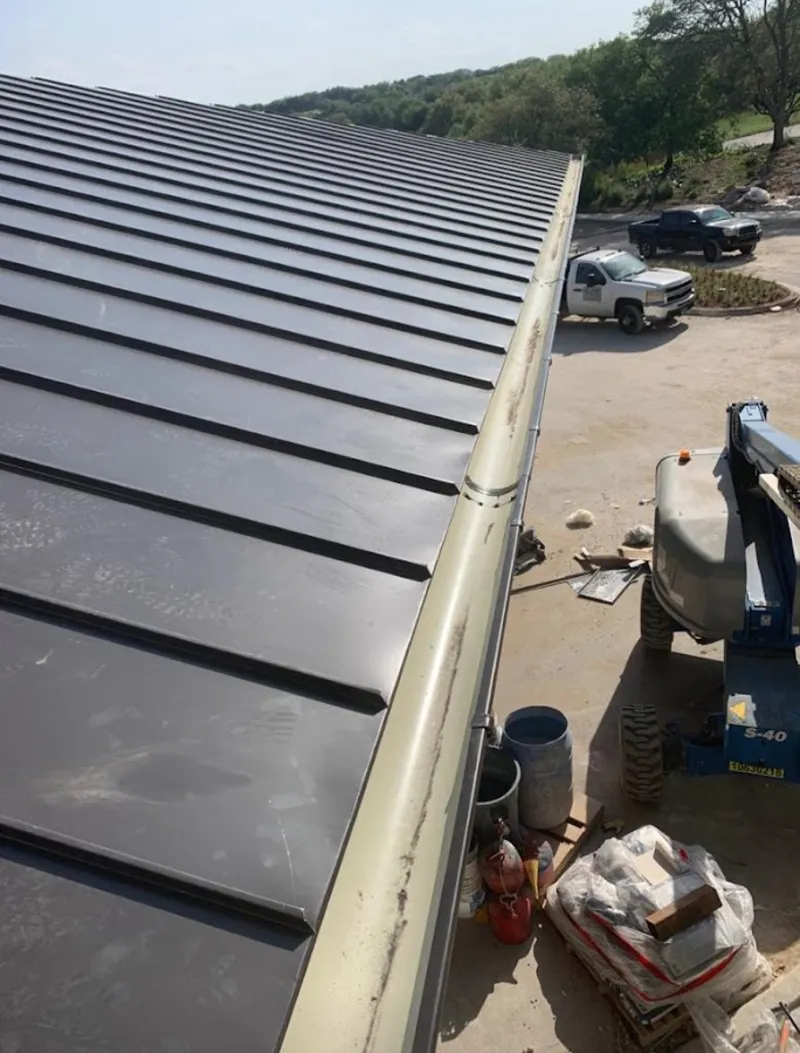 Standing seam panel and gutter detail on a metal roofing jobsite in Lincoln Park